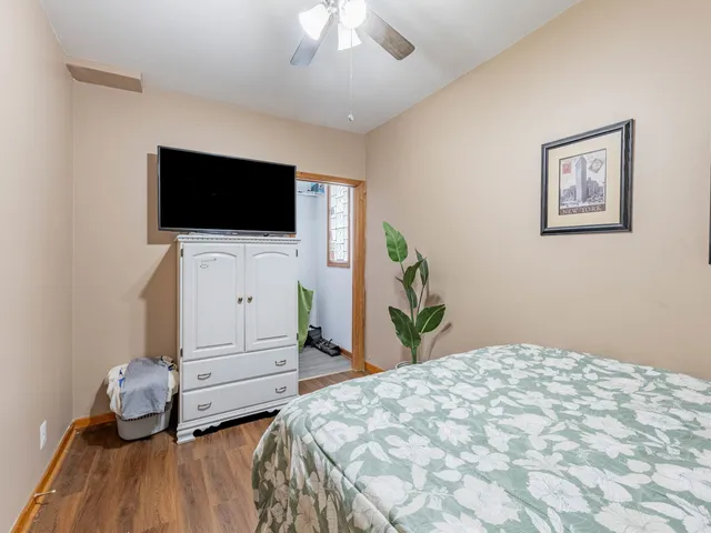 a bedroom with a bed and flat screen tv