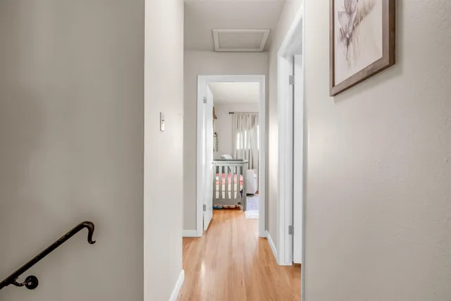 a bedroom with baby crib and a window
