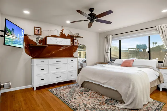 a view of a hallway with wooden floor and closet