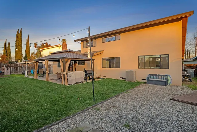 a front view of house with yard and outdoor seating