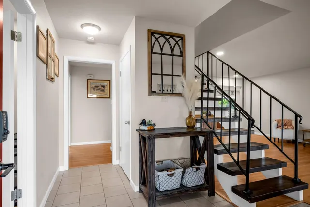 a view of an entryway with wooden floor and stairs