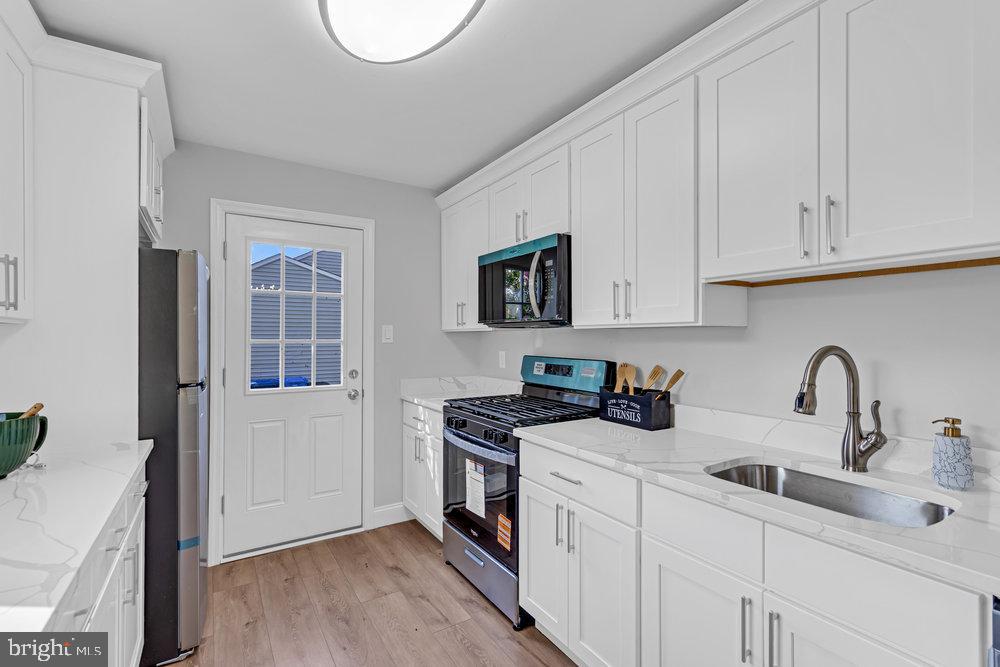 328 Ithaca Avenue Delran, NJ 08075 - Photo 10 of 24 a kitchen with stainless steel appliances granite countertop a stove a sink and white cabinets