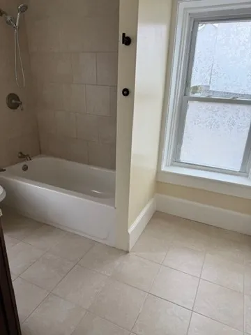 a bathroom with a bathtub and a shower