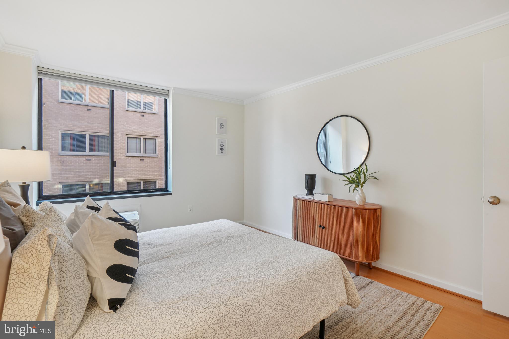 2141 P Street Northwest, Unit 709 Washington, DC 20037 - Photo 19 of 23 a bedroom with bed and wooden floor