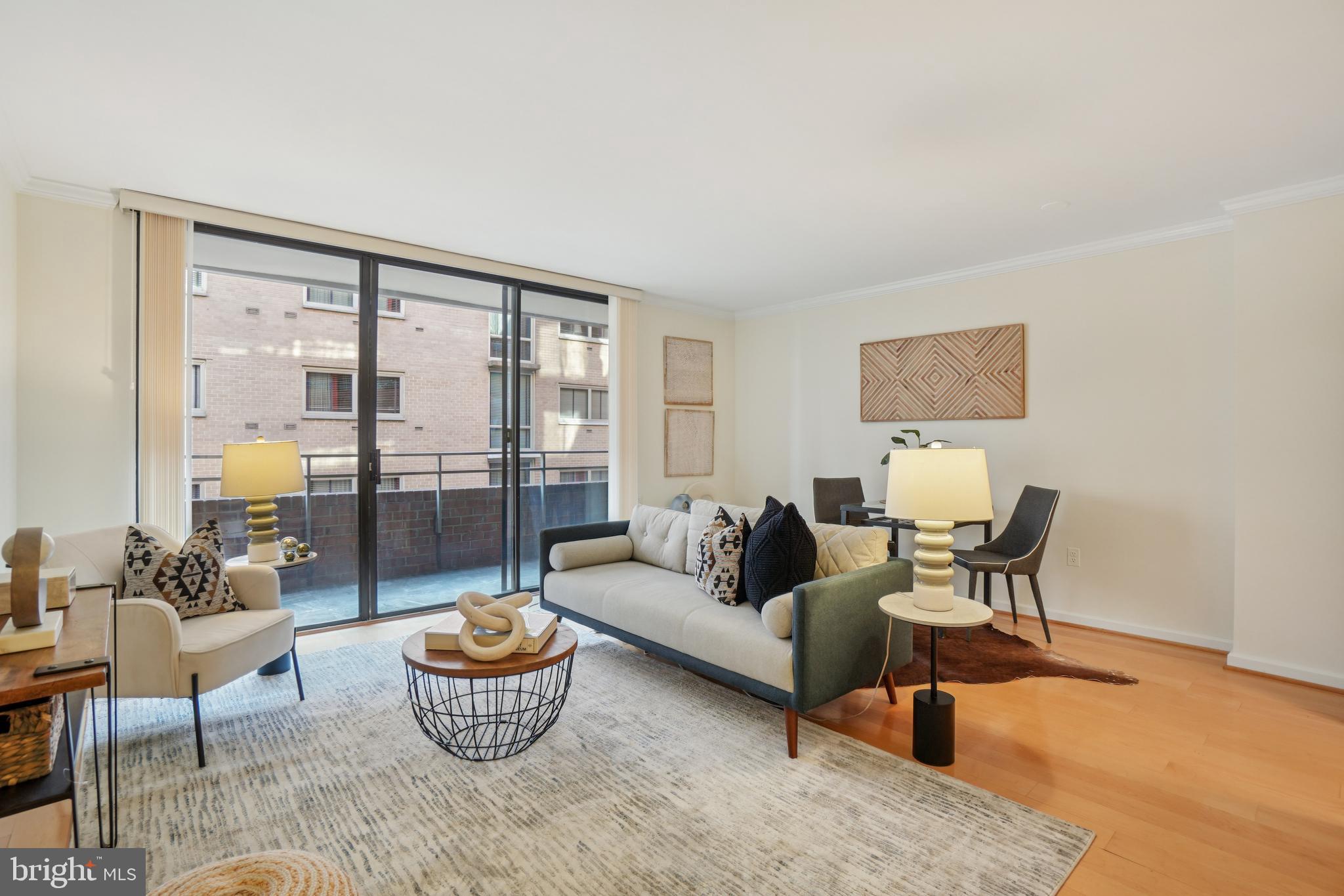 2141 P Street Northwest, Unit 709 Washington, DC 20037 - Photo 2 of 23 a living room with furniture and a large window