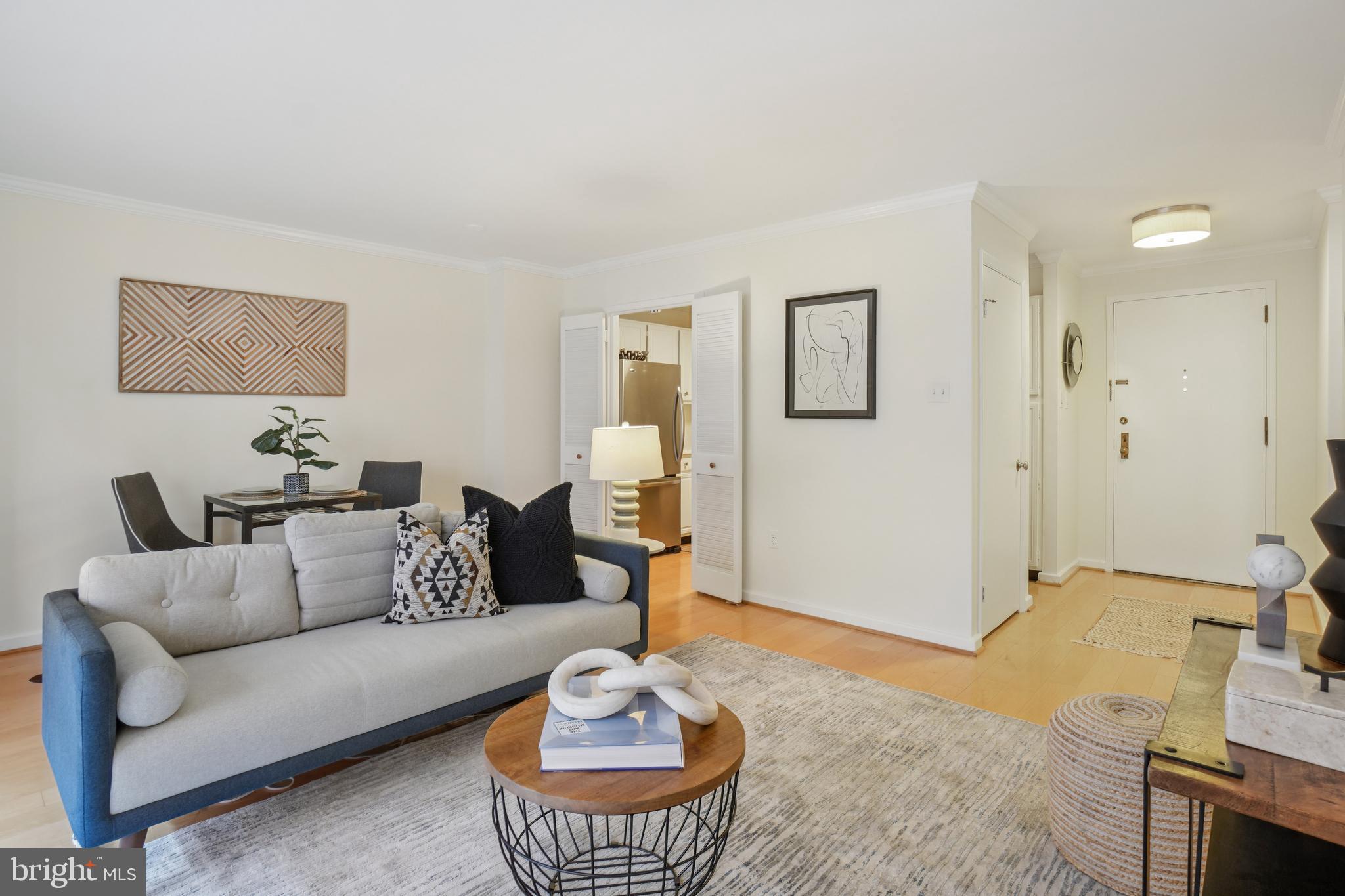 2141 P Street Northwest, Unit 709 Washington, DC 20037 - Photo 8 of 23 a living room with furniture and a wooden floor