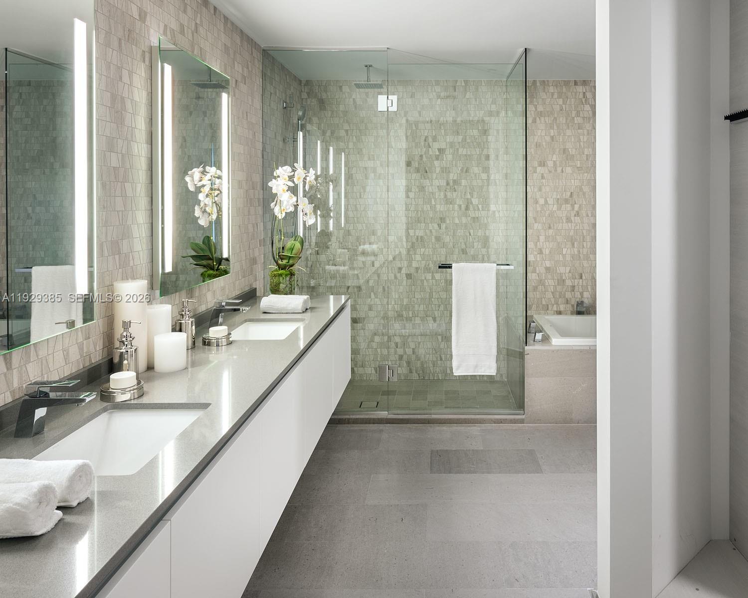 88 Southwest 7th Street, Unit 2501 Miami, FL 33130 - Photo 14 of 38 a large bathroom with a double vanity sink and a mirror