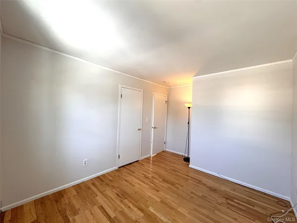 a view of a room with wooden floor
