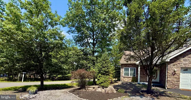 a view of a house with a tree