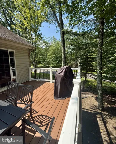 a view of balcony with wooden floor and outdoor seating
