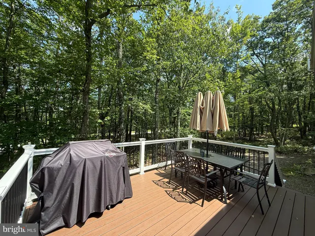 a view of balcony with wooden floor and outdoor seating