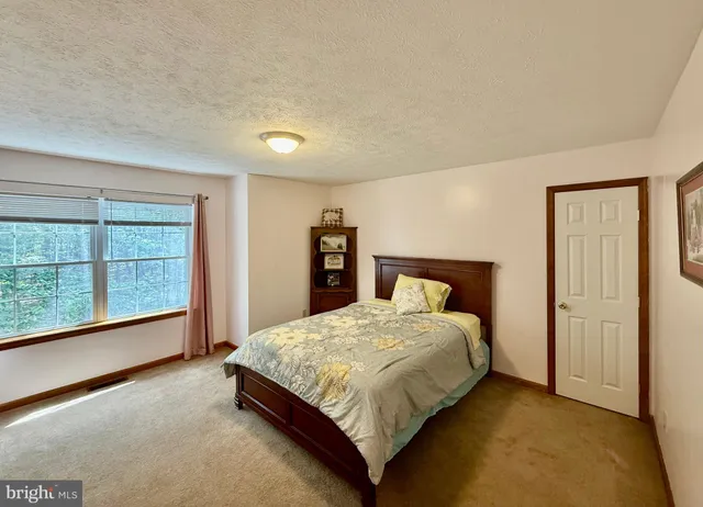a living room with furniture and a night stand