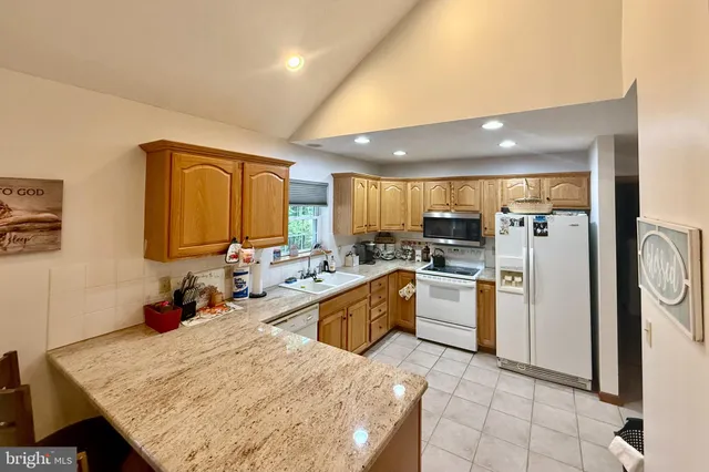 a kitchen with sink stove and cabinets