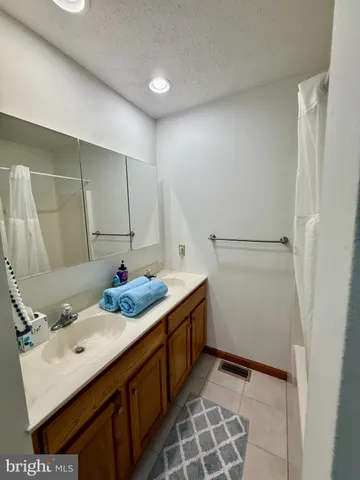 a kitchen with stainless steel appliances kitchen island granite countertop a sink refrigerator and cabinets