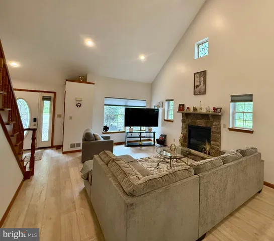 a living room with furniture and a fireplace