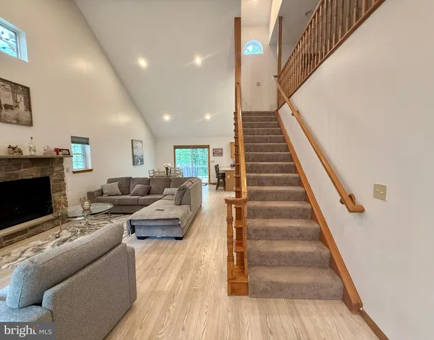 a living room with furniture a flat screen tv and a fireplace