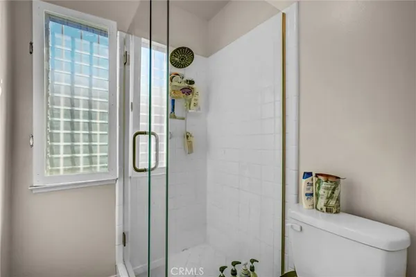 a bathroom with a shower and a toilet