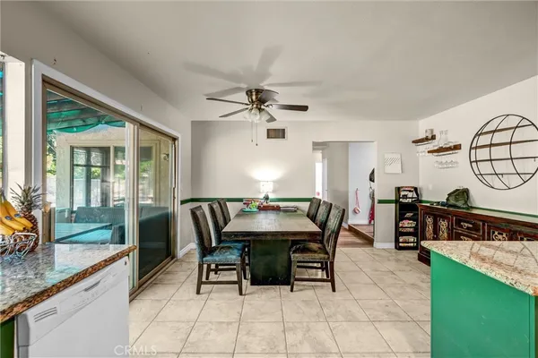 a dining room with furniture a rug and a large window