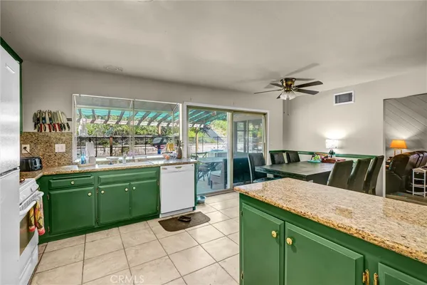 a kitchen with sink and large window