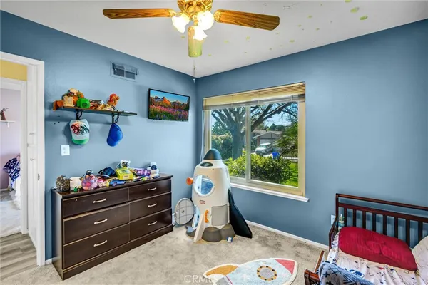 a bedroom with a bed table and window