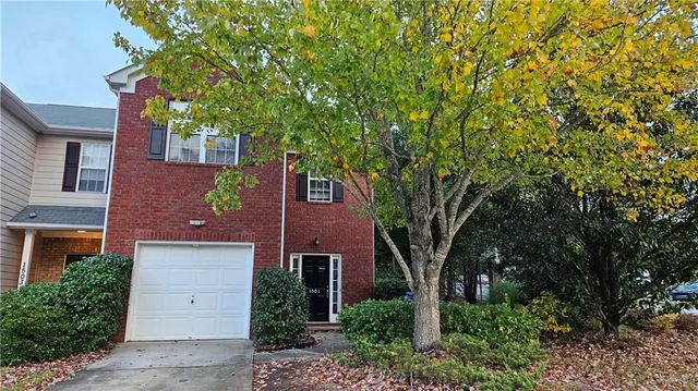 front view of a house with a tree