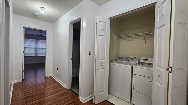 a view of a storage & utility room with closet wooden floor
