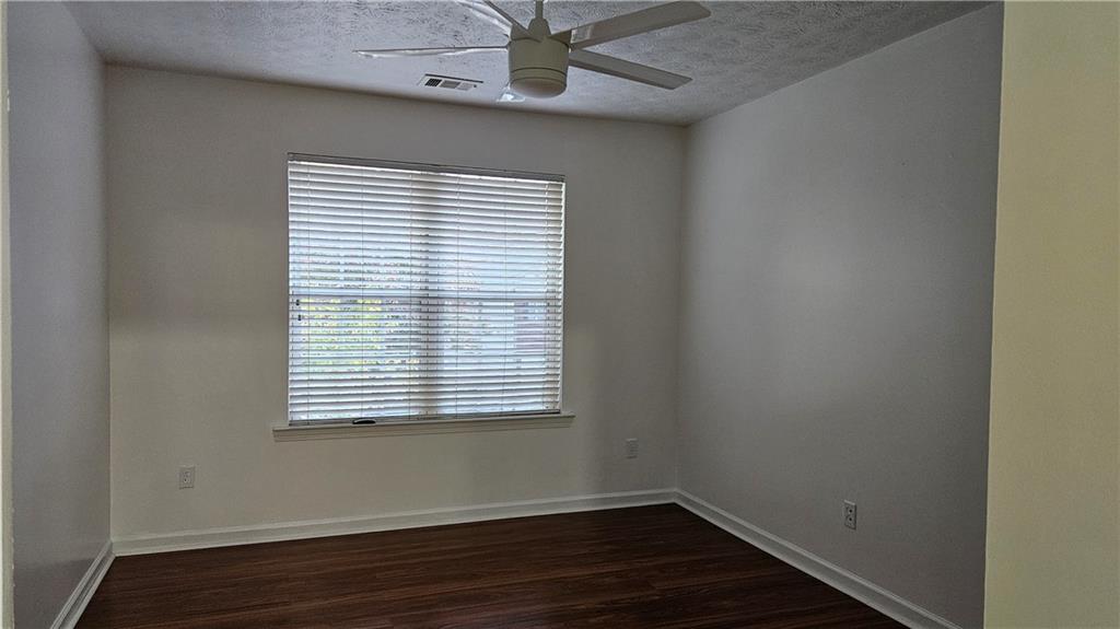 1501 Parc Main Street Lawrenceville, GA 30046 - Photo 14 of 16 a view of an empty room with wooden floor and a window