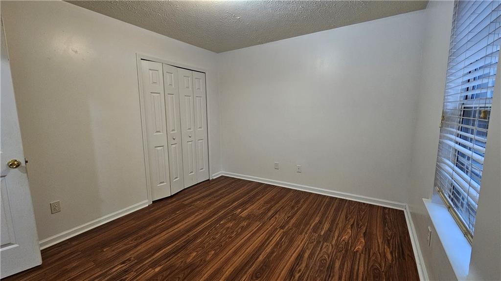 1501 Parc Main Street Lawrenceville, GA 30046 - Photo 15 of 16 a view of an empty room with wooden floor and a window