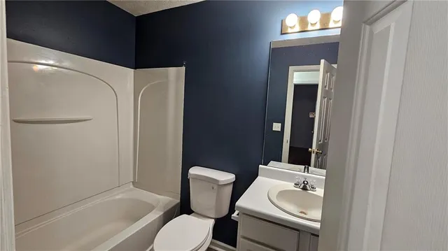 a bathroom with a toilet a sink and bathtub