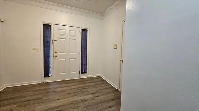a view of a room with wooden floor