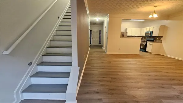a view of an entryway with wooden floor