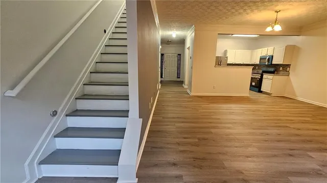 a view of an entryway with wooden floor