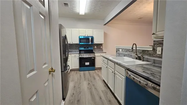 a kitchen with stainless steel appliances granite countertop a stove and a sink