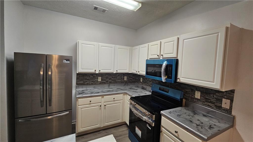 1501 Parc Main Street Lawrenceville, GA 30046 - Photo 7 of 16 a kitchen with a refrigerator stove and microwave