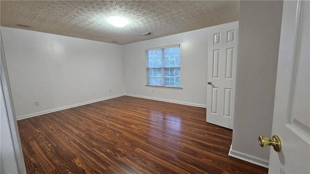 1501 Parc Main Street Lawrenceville, GA 30046 - Photo 9 of 16 wooden floor in an empty room with a window