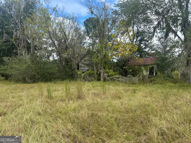 a small pool with trees in the background