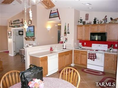 8421 Red Rock Ridge Court Tucson, AZ 85742 - Photo 6 of 16 a kitchen with a sink stove and cabinets