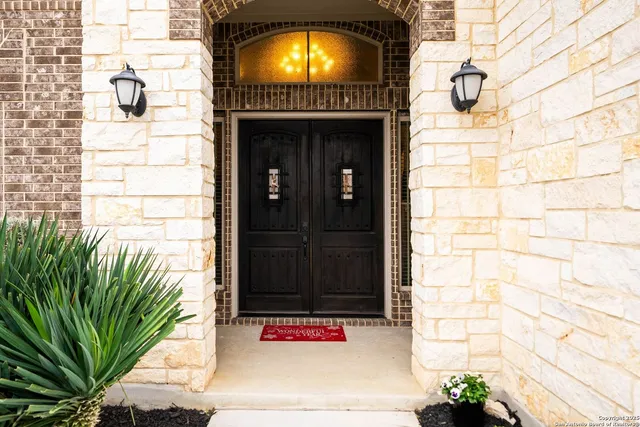a living room with furniture a fireplace and a large window
