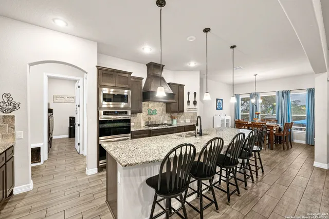 a bathroom with a granite countertop toilet sink and mirror