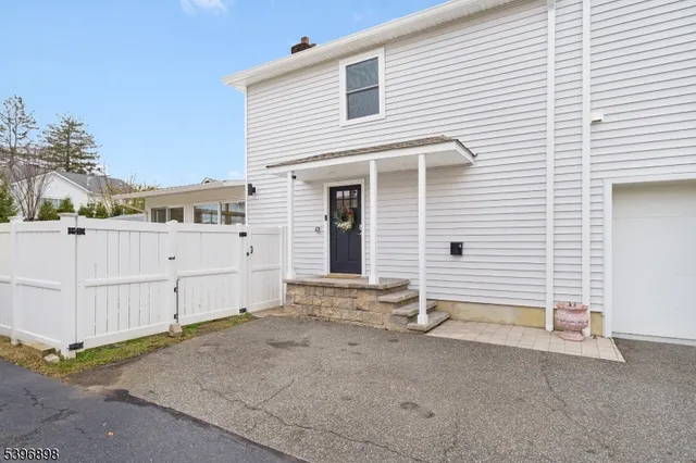 a view of a house with white fence