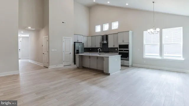 a view of a kitchen with a sink a refrigerator and window