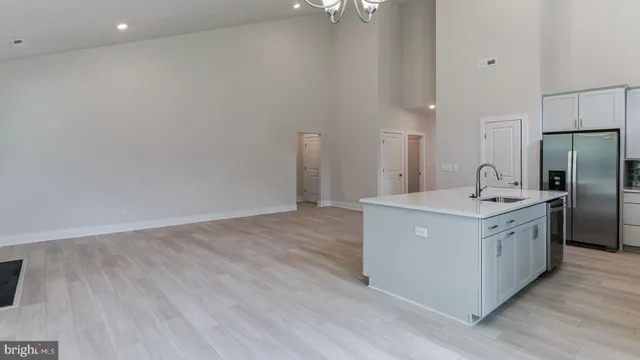 a kitchen with stainless steel appliances a sink and a refrigerator