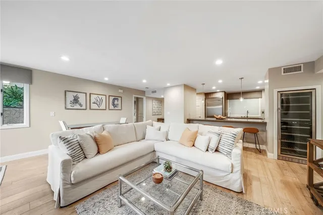 a living room with furniture and kitchen view