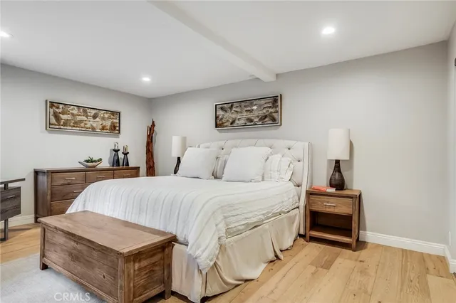 a spacious bedroom with a bed and a table in it