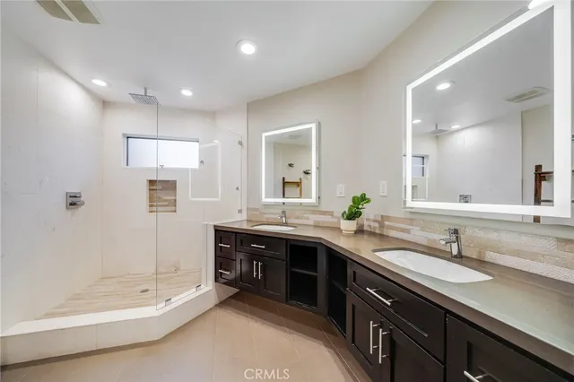 a bathroom with a granite countertop sink a toilet and shower