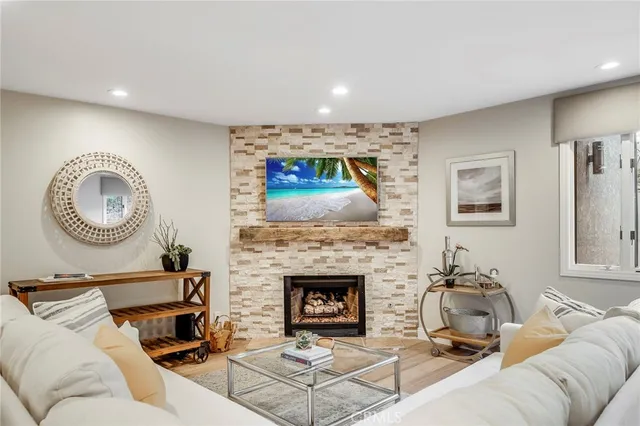 a living room with furniture a mirror and a fireplace