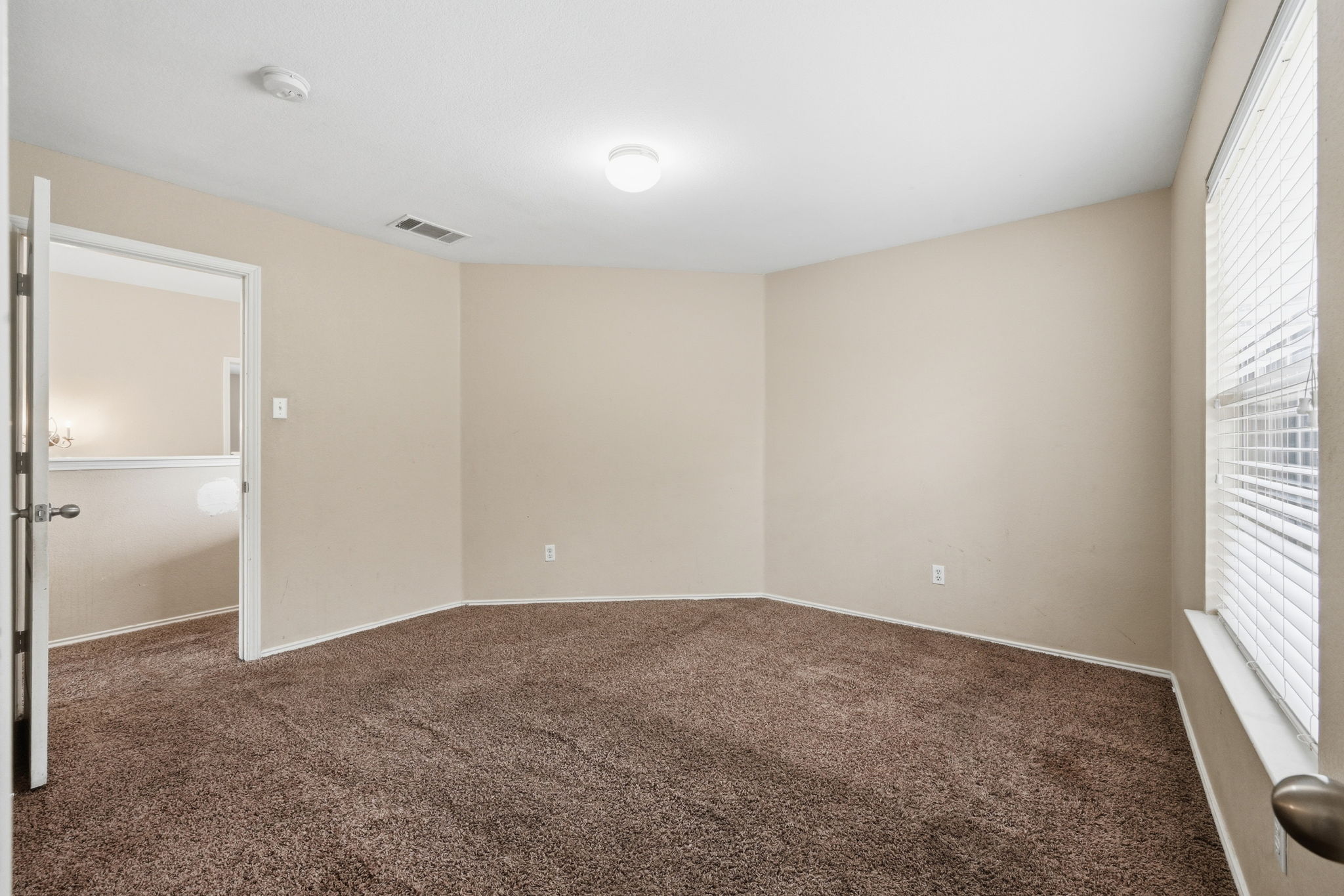12621 Waynespur Lane Elgin, TX 78621 - Photo 16 of 34 an empty room with windows and closet