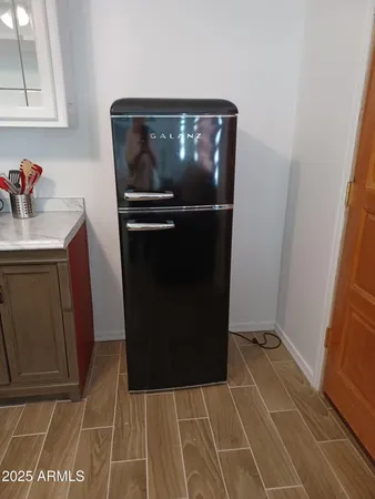 a bedroom with a bed and a lamp on table