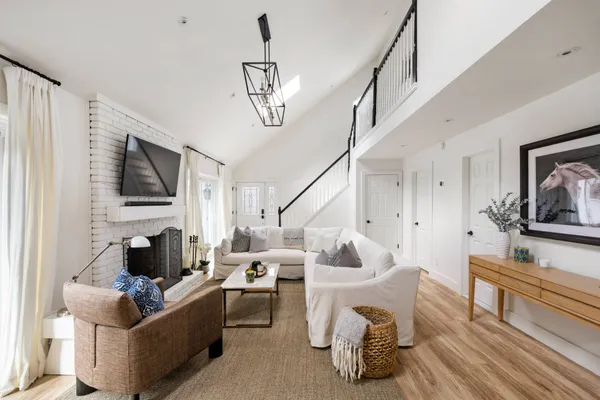 a living room with furniture and a chandelier