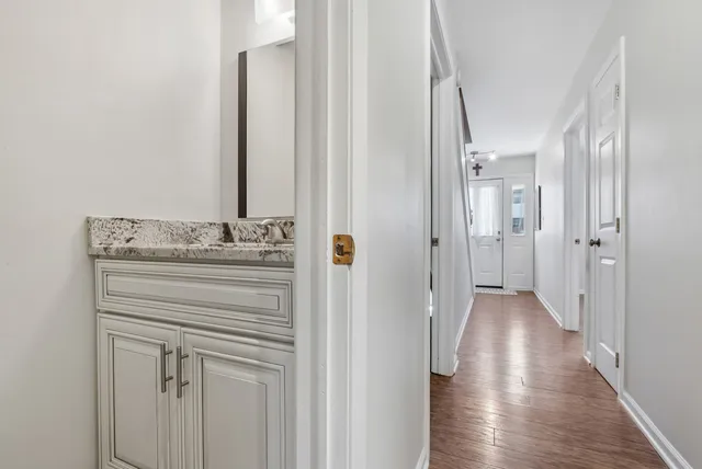 a bathroom with a granite countertop sink a mirror and shower view